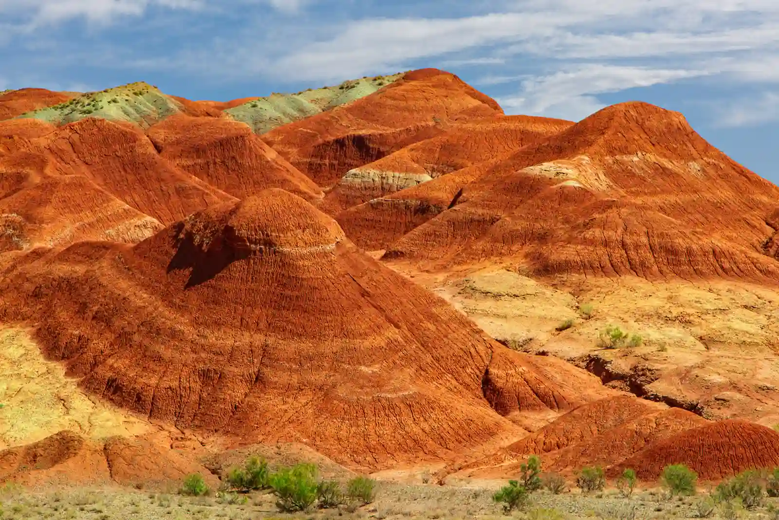 Cone-shaped red clay hills of the Aktau Mountains in Altyn Emel